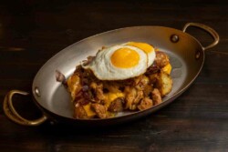 Breakfast potatoes, onions, wild mushrooms, chicken apple sausage, two eggs sunny side up, American cheese