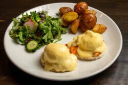 2 delicately poached eggs and silky hollandaise sauce; served with roasted garlic potatoes and fresh salad